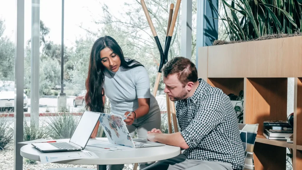 Small business owner reviewing website on laptop